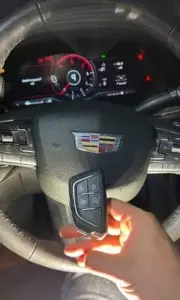 Mobile automotive locksmith programming a smart car key in Miami.